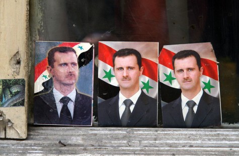 bashar_alassad_portraits_in_a_window_damascus_syria