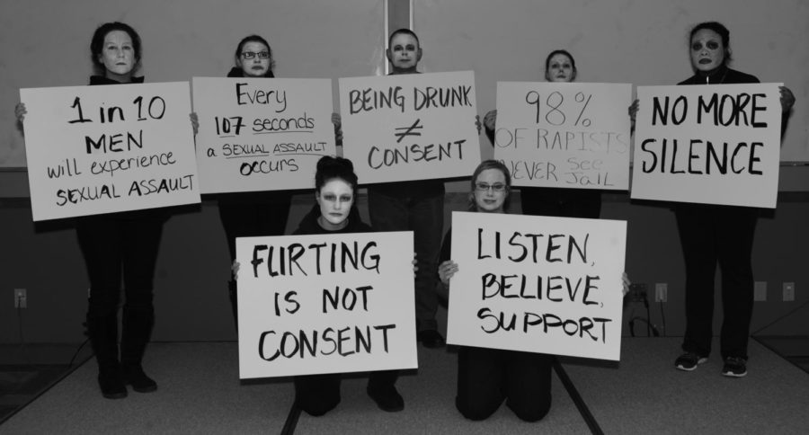 Participants in the “living display” hold up signs during the Sexual Assault Awareness at Ellsworth Air Force Base, S.D., April 1, 2016. 