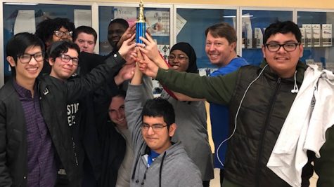 Mr. Young (second from right) with his students holding up the Trophy from Chess Club.